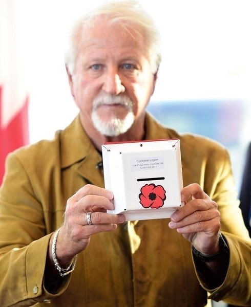 Dan Kroffat holds the new poppy box which is built to be more secure and less prone to theft.
