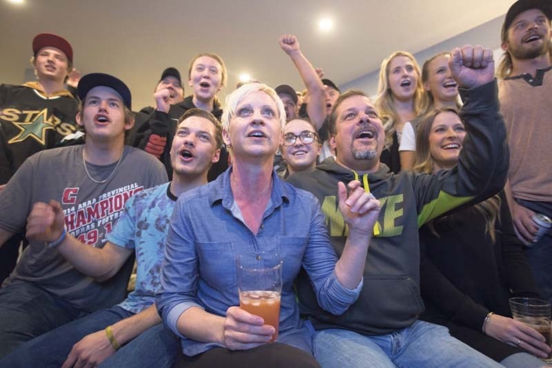 Friends and family of Justin Dowling cheer in Cochrane on October 25, 2016 as he takes the ice for the Dallas Stars in his very first ever NHL game.