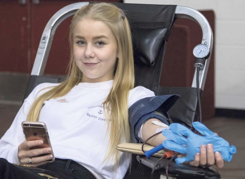 Tailleur Oulton, Young Blood for Life ambassador, donates blood for the first time while at Cochrane High School on November 4, 2016. The school organized a Young Blood for