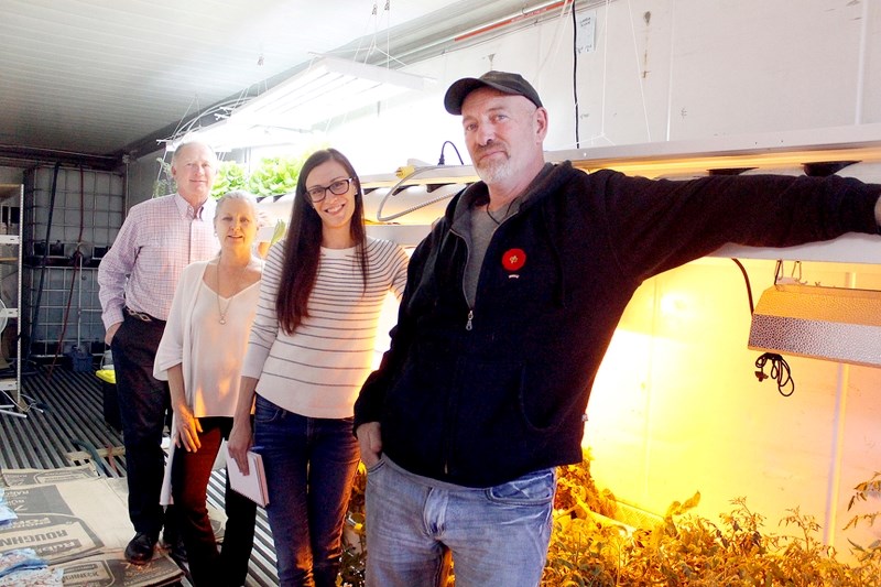 From left: Mike Medwid and Linda Tyler of Response Energy, project manager Sandie De Bonnault and founder Paul Hughes of Grow Calgary stand in the insulated Seacan veggie