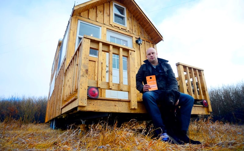 Gregg Taylor and his tiny house in Springbank on November 18. Taylor&#8217;s home has been a focus of Rocky View County bylaw officials and neighbours who are less than
