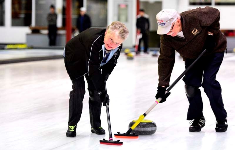 David and Sharon McPherson of Redwood Meadows sweep down the ice.