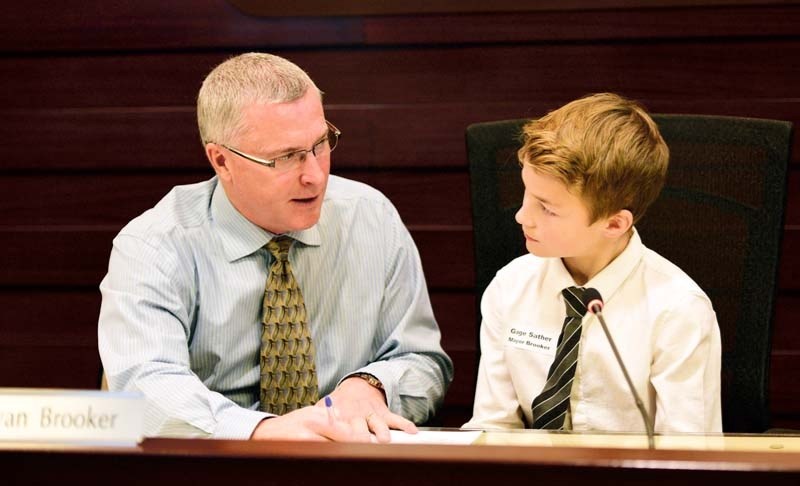 Town of Cochrane Mayor Ivan Brooker and Gage Sather participate in the mock youth council.