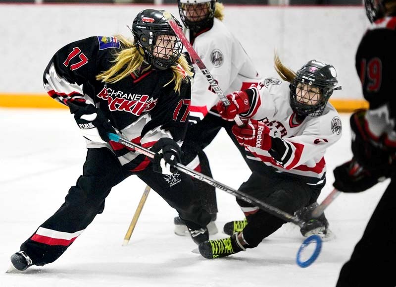 U14 Cochrane Rockies ringette player Presley Stene scores a goal while battling with NW Calgary player Jennifer Audet.