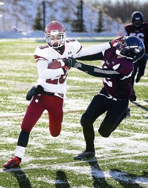 Tae Gordon straightarms an opposing player. Gordon was named league MVP.