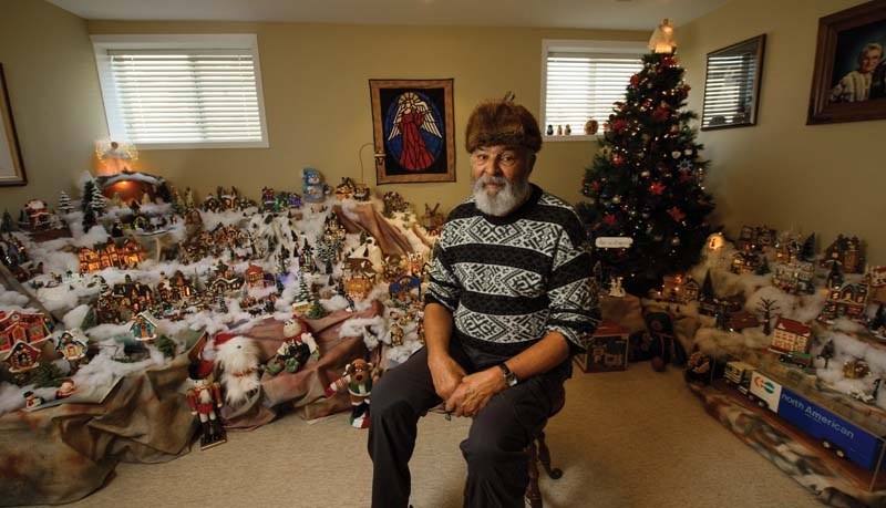 Richard Whitford poses in front of his Christmas village.