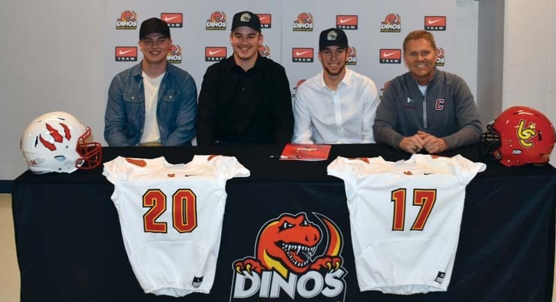 Cobras Dylan Gingrich-Hadley and Zach Rabe (middle) join Kane Boklaschuk (left) and Cobras coach Rob McNab (right) at the University of Calgary Dinos signing last week
