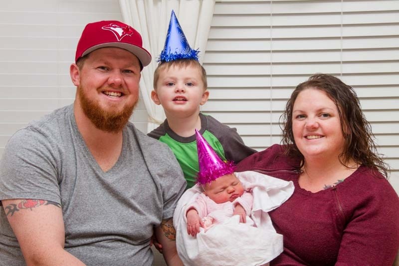 Happy parents, Kylee and Jeremy Schmidt, along with big brother, Cooper, celebrate the arrival of new family member, Charlee Ann.