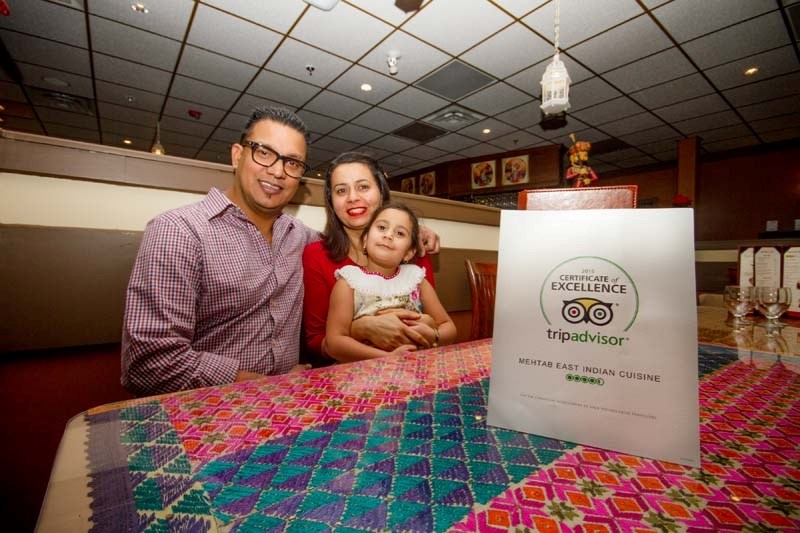 Jag Thind and his wife, Gunjeet, and daughter, Asees, were all smiles after being recognized by Tripadvisor with a Certificate of Excellence for their restaurant, Mehtab East 