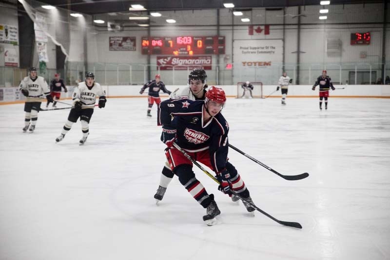 Joey Stensland fights for puck position in Game 3 of the Heritage Junior Hockey League&#8217;s semi-final matchup between the Cochrane Generals and the Banff Bears. The