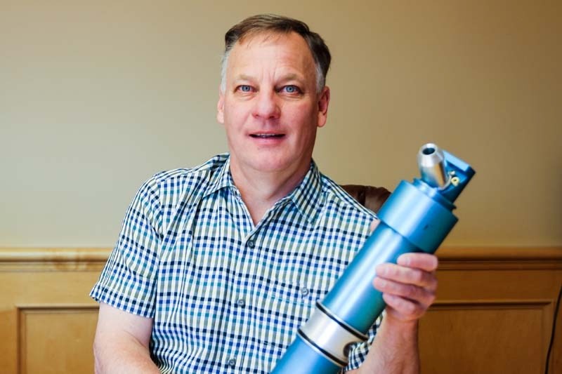 Inventor and Cochranite Cam Cote with his latest invention, InteliRain the robotic sprinkler system that would conserve water compared to traditional systems.