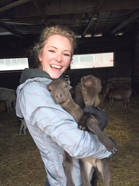 Chris Kay&#8217;s wife, Jessa, cuddles with goats at Early Dawn Goat Dairy, where goat yoga excursions will take place later this month.