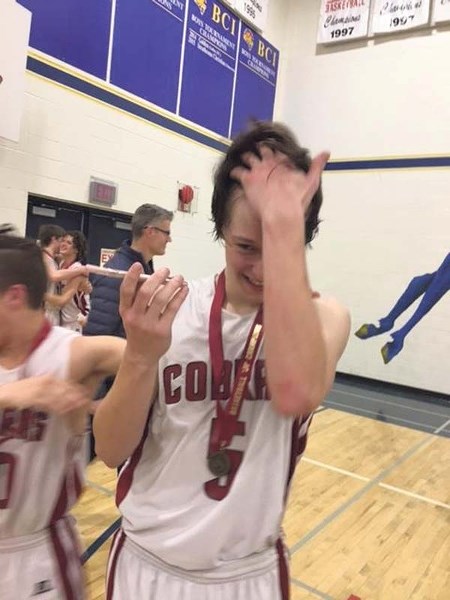 Cochrane Cobras player Jonah Bosch shares the excitement of his junior varsity team&#8217;s championship win with his father, Jeff, who watched the entire game live on