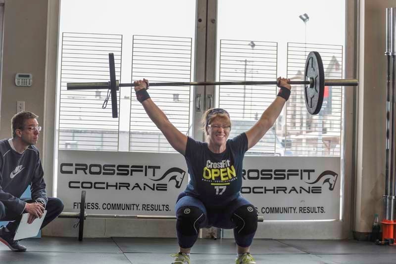 CrossFit Cochrane athlete Karen McCue powers her way through a set of snatches during the third week of the CrossFit Open worldwide competition.