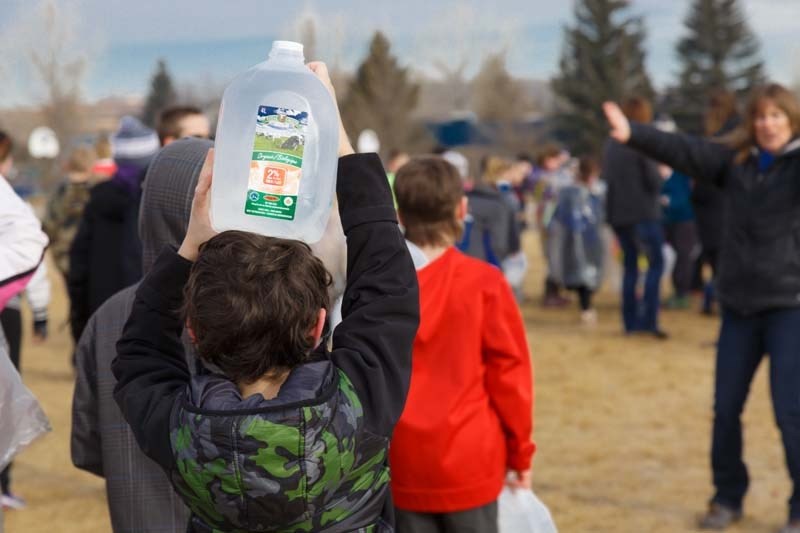 Students of Elizabeth Barrett School walk around the playground field with water filled milk jugs to raise money for a water well for a rural community in Nicaragua on