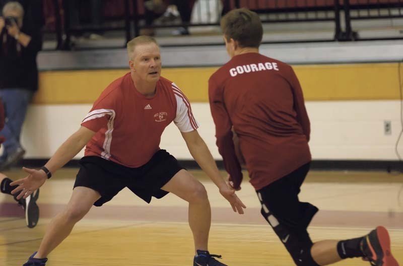 Randy Peron, left, tries to block the ball against a student durning the student teacher basketball game on March 24.