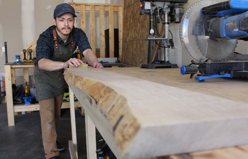 Joshua Clarke works on a headboard for a new bed frame at his garage workshop in Cochrane, Alberta on March 22, 2017.