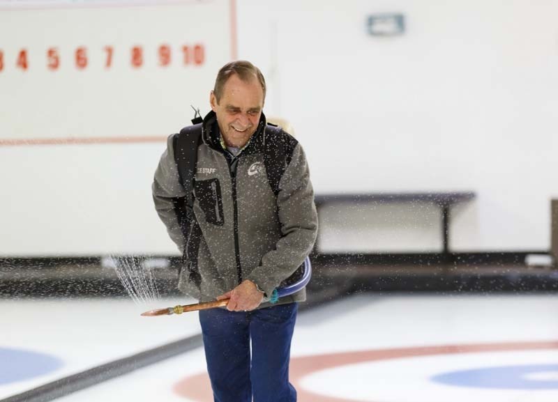 Ice technician Al Whapham pebbles the ice at the Cochrane Curling Club.