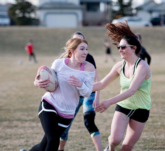 Brittany Lachapelle, left, evades Sierra Dube during rugby practice for The Bow Valley Rugby Club on Tuesday, April 18, 2017. The club created an all girls team this year.