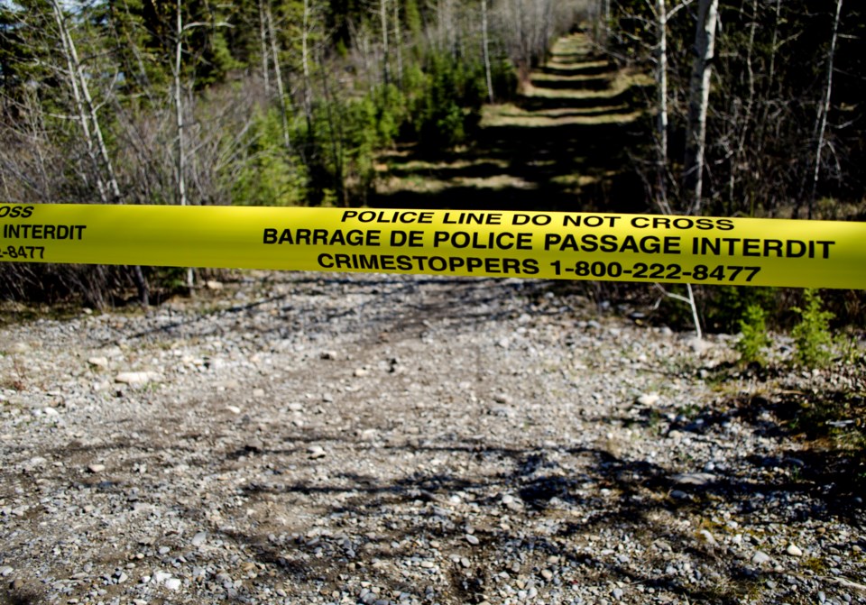 RCMP Special Tactical Operations members searching the area along Highway 22 where human bones were found yesterday to identify where the bones originated from in Redwood