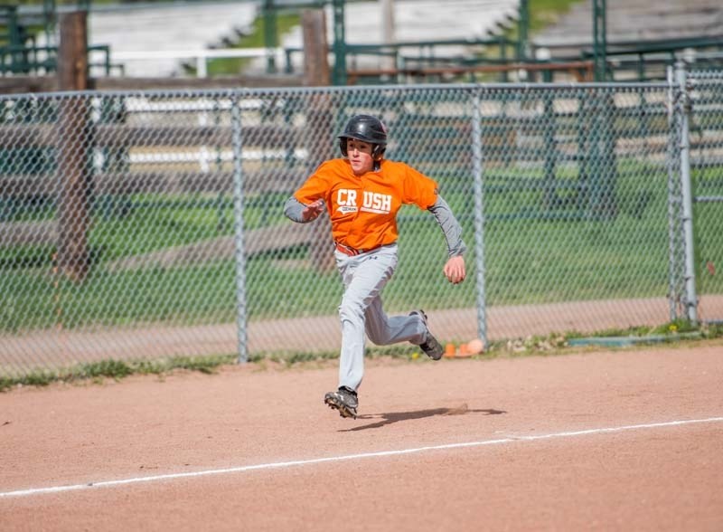 Justin Ferguson races for the base during Cochrane Crush game action on May 13.