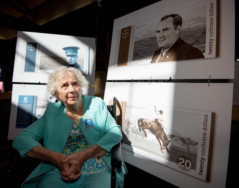 Irene Copithorne, 92, beside the $20 note of Cochrane currency, on which her husband Clarence is featured, during the Cochrane currency unveiling at the ATB Financial branch