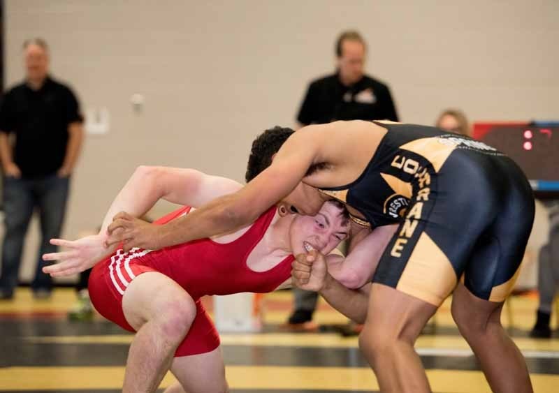 Cochrane Cowboys Wrestling Club teammates Hunter Smith (left) and Connor Pointen face off in the Canada Summer Games qualifying matches at Rundle College Junior and Senior