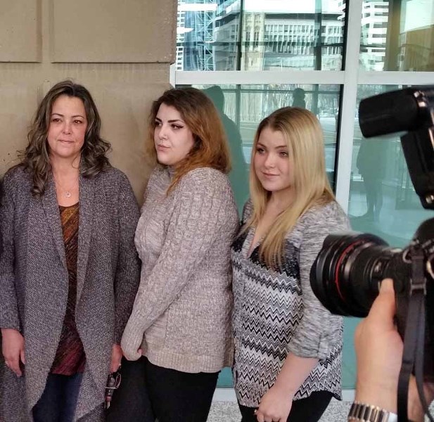 Lisa Fox stands with daughters Kylie and Taylor French at the Calgary Courthouse after Allan Dean Griffin was found guilty of sexual assault March 29.
