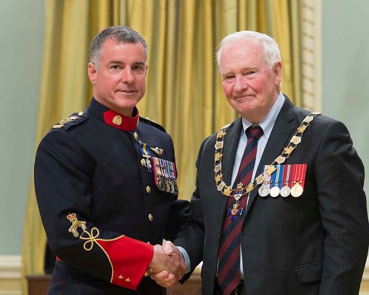Gov. Gen. David Johnson, right, presented the Member insignia of the Order of Merit of the Police Forces to Superintendent Raymond Robitaille.