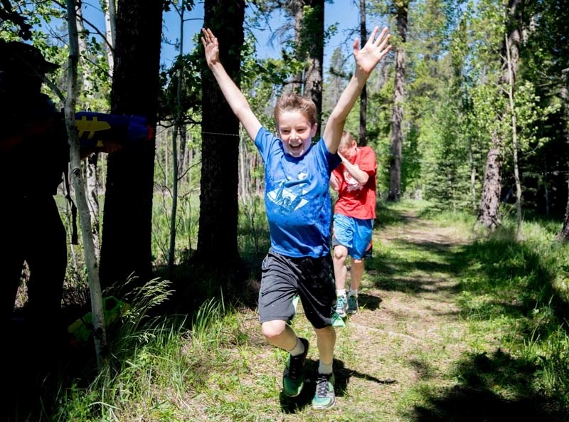 Taylor Kellock, reacts to being sprayed with water during Bragg Creek&#8217;s Banded Peak School&#8217;s annual walkathon. The event raised $13,000 to assist with school