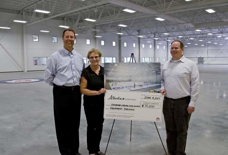 Excitement builds for the anticipated opening of the new curling club as President of the Curling Club Society David Cooper and managing director Barb Gibson accept a $75,000 