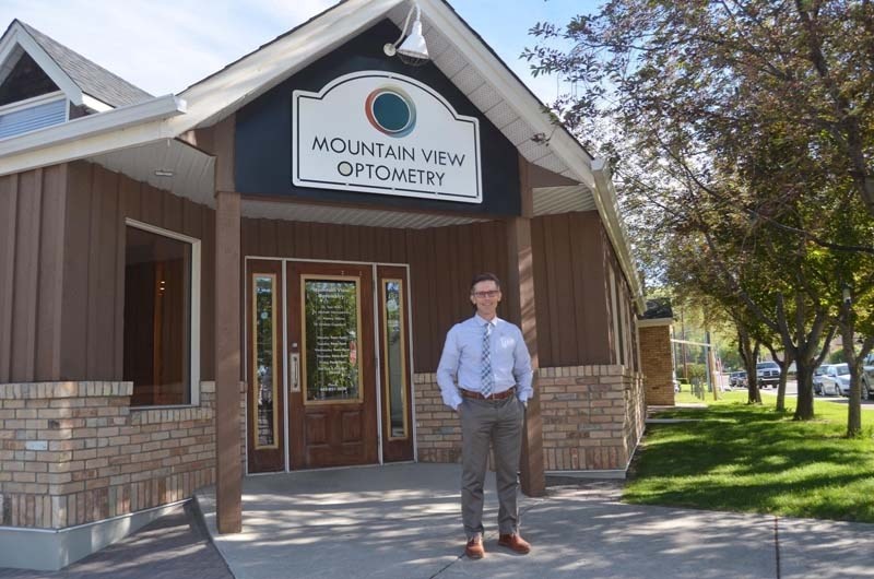 Tom Wilk stands outside Mountain View Optometry in Cochrane.