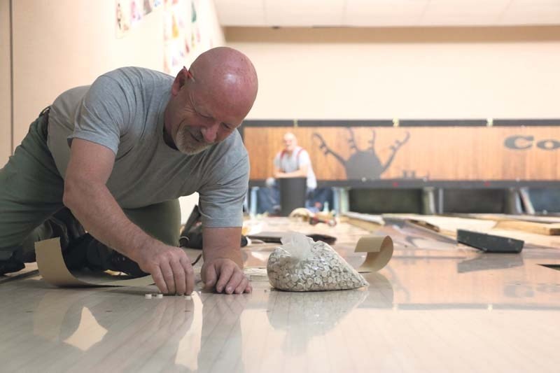 Bowling lane technician Nelson Joseph works on installing new lanes at the Cochrane Lanes as part of the first major upgrade to the popular social spot since it opened nearly 