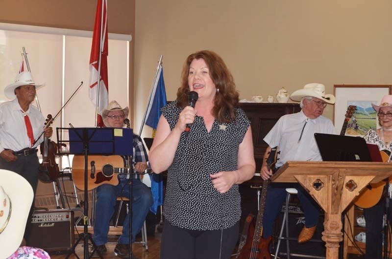 Lori Sigurdson, Alberta&#8217;s minister of seniors and housing, speaks at the annual Bethany Cochrane Stampede Barbecue Aug. 14.