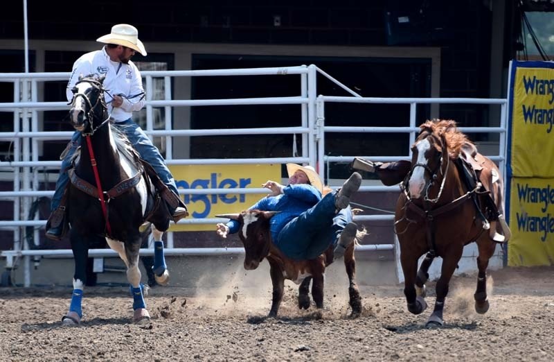 Cochrane&#8217;s Tanner Milan competes in the steer wrestling finals at the Calgary Stampede in Calgary on Sunday, July 16, 2017.