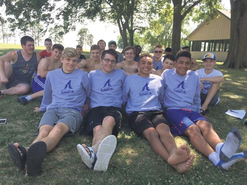 Team Alberta wrestlers Connor McNeice, Hunter Smith, Elijah and Isaiah Springer relax outside at the Legends of Gold training centre in South Dakota.