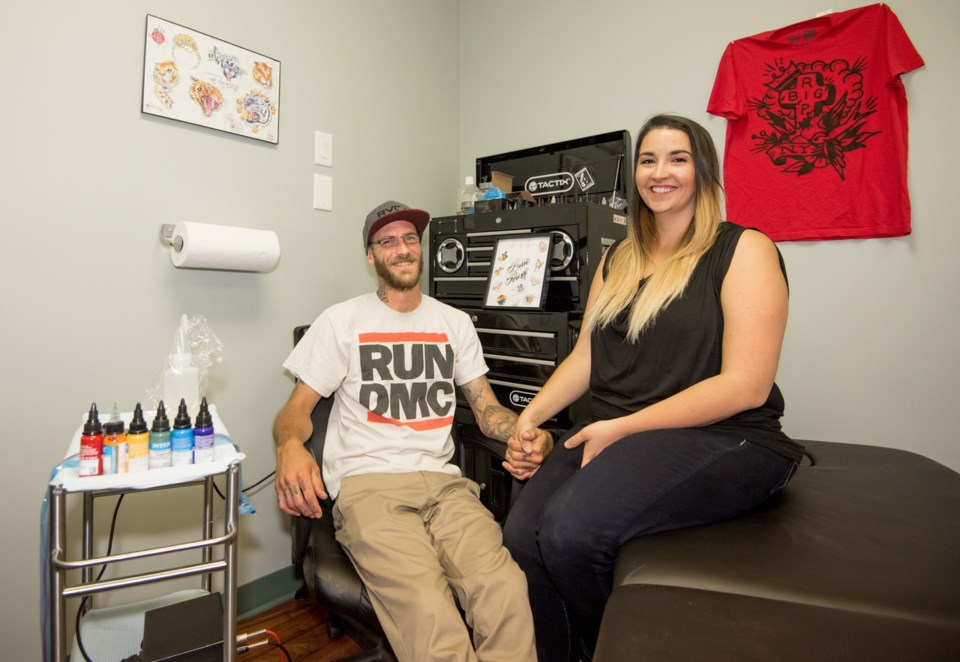 Jordan Shea and Rebecca Pare at their new tattoo business Sink or Swim Creations in Cochrane. The pair are donating a percentage of flash tattoos to Camp fYrefly, an