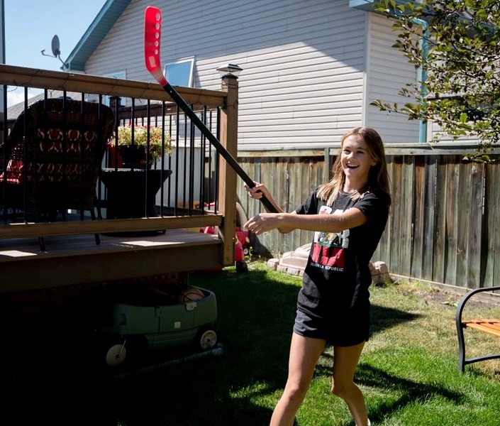 Lucy Toombes, 13, plays floor hockey at her mother Susan Watkins&#8217; day home. Watkins started her day home nine years ago and opted to become regulated through Play Days