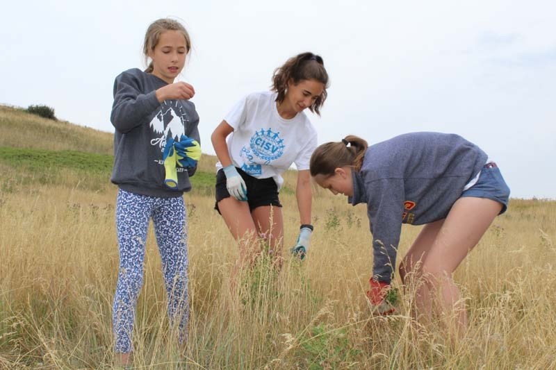 Grace Lawton (centre) spent her summer aboard the Peace Bus. The Grade 11 Cochrane High School student and a dozen other teenagers from across the country began their journey 