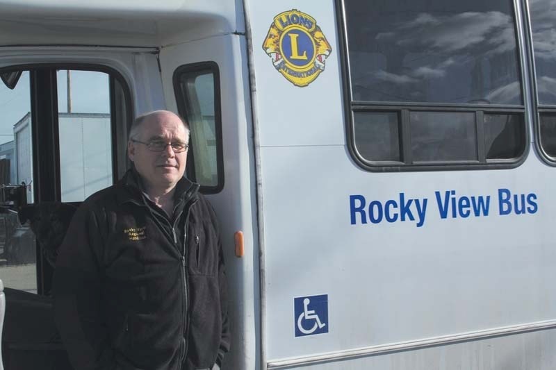 Paul Siller, executive director of the Rocky View Regional Handibus Society poses in front of a Rocky View Bus.