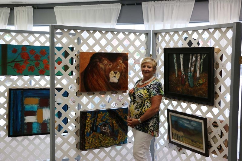 Local artist Gina Groot showcases a few of her many art pieces during her show at Final Touch Art Studio on Sept. 9.