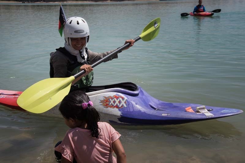 Afghan girl leaning to kayak.