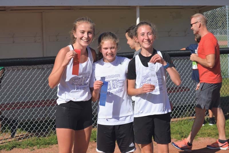 St. Tim&#8217;s runners Holly Moores, Sofia Preece and Makenna Myatt show off their ribbons.