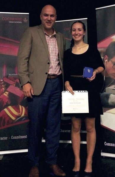 Cochrane High School student Sarah Skarsgard accepts her Governor General&#8217;s Academic Medal from principal Eddie Polhill.