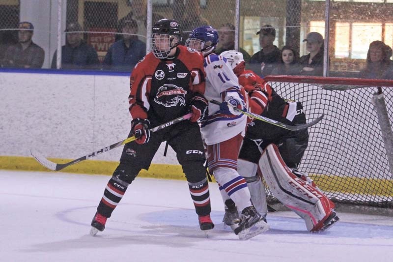 Bisons defender Tyrell Bauer tries to clear the front of the net. Bauer and his team took on the Canadian Women&#8217;s Olympic team on Oct. 3.