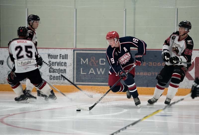 Cochrane Generals forward Talus Hume keeps the puck away from the Blackfalds Wranglers.