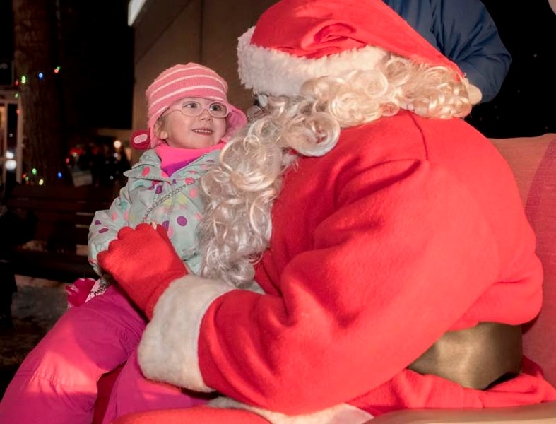 Kyla Summerhays, 4, sits on Santa&#8217;s lap during the annual Light up in Historic Downtown on Saturday,