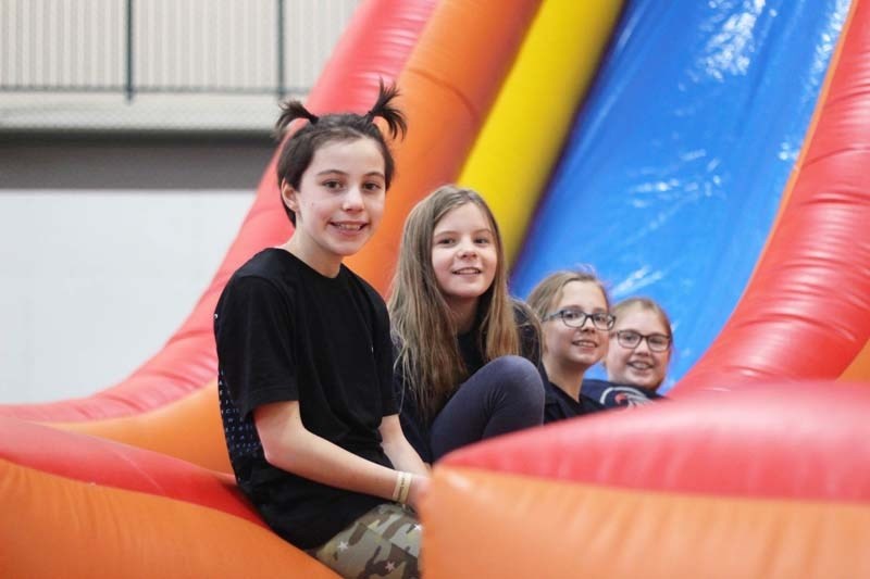 Ruby Manolakas, Natasha Guerin, Mavi Sokoloski and Trinity Peters play on the bouncy castle as part of an all-day event at Spray Lake Saw Mills Family Sports Centre to kick