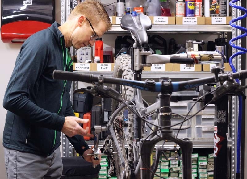 Graham Pye works on a bike at the Bike Bros shop.