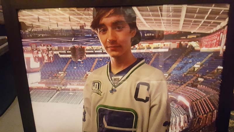 A photo of Zacahry Allen attending a Canucks game with his dad.
